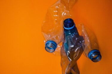 blue plastic bottle orange background