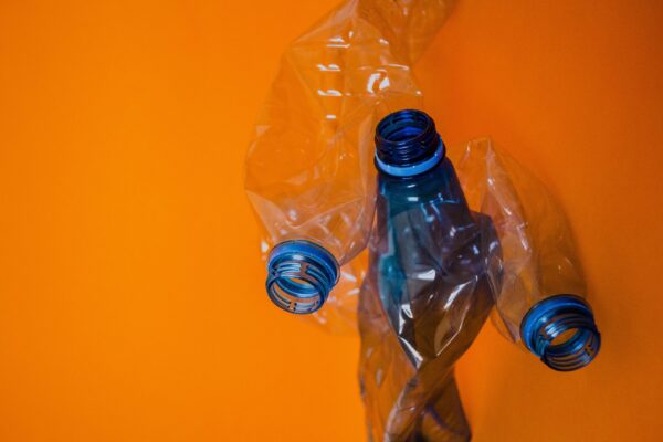 blue plastic bottle orange background